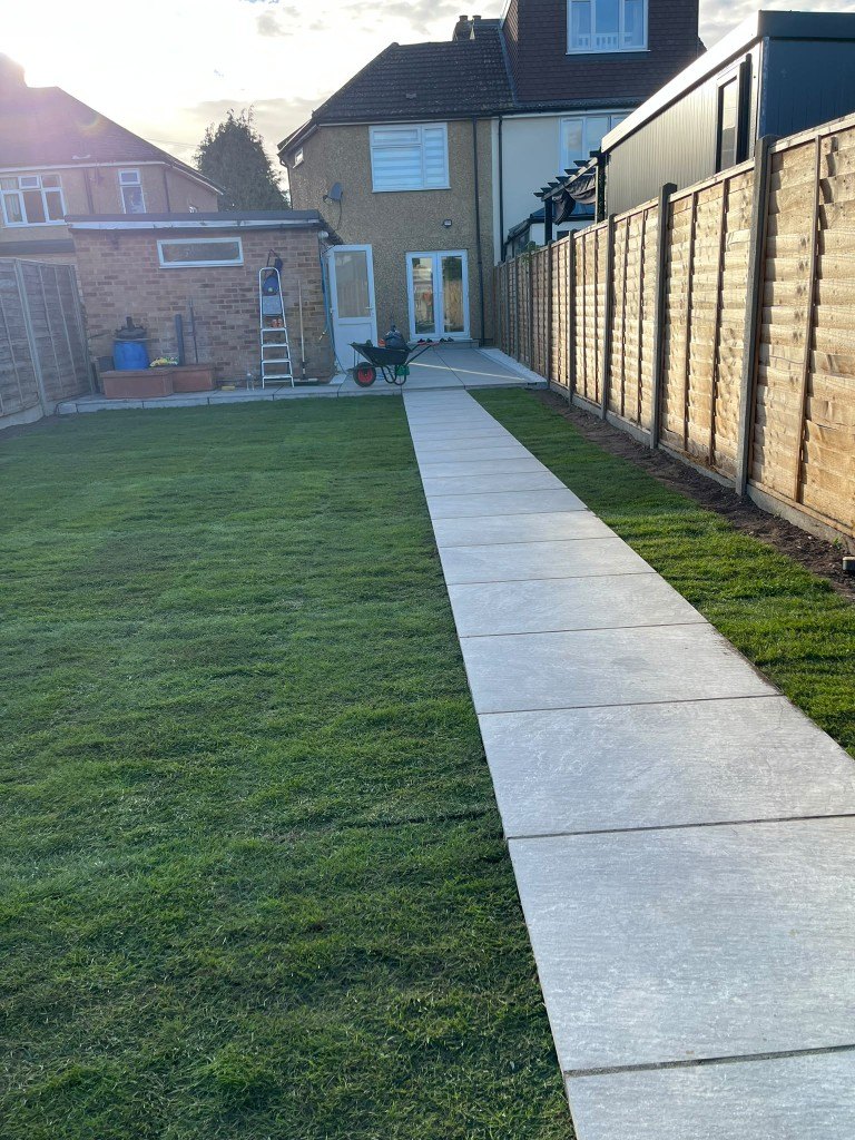 The same garden after: new lawn and a straight stone path to the house